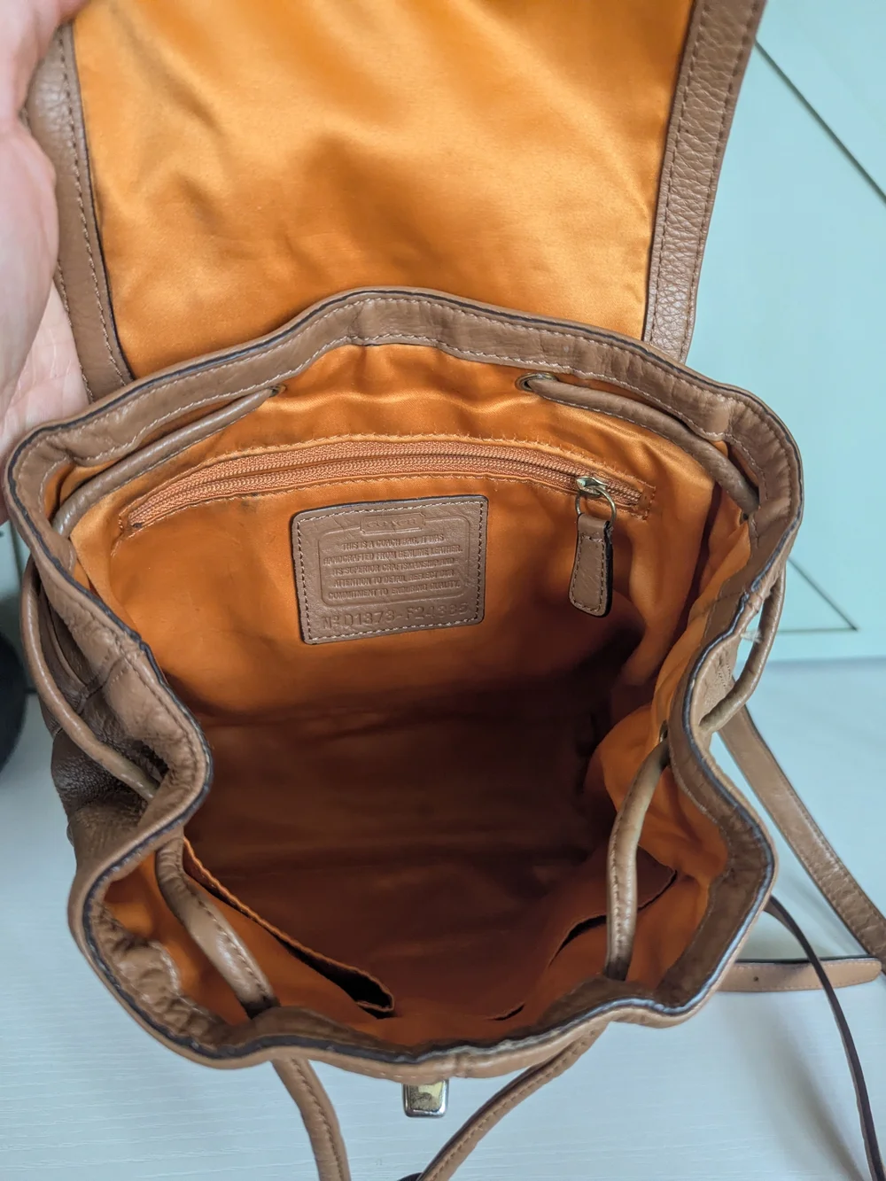 Coach Pebbled Leather Drawstring Backpack in Tan